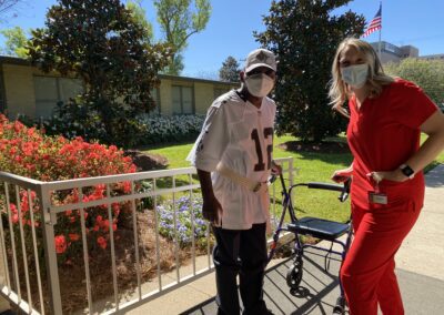 staff and patient standing outside